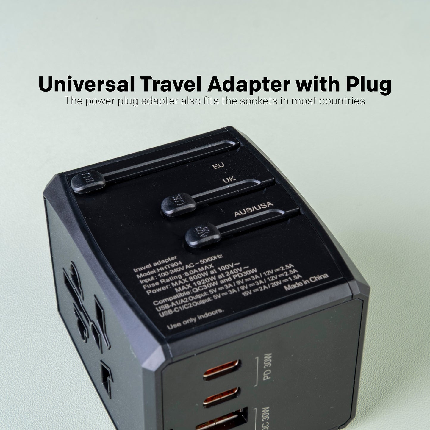 Universal travel adapter with plug on a light gray background