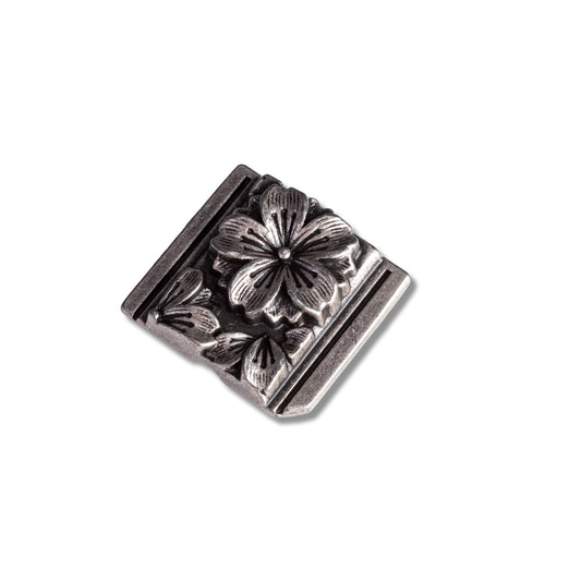 Silver floral square decorative element on a white background