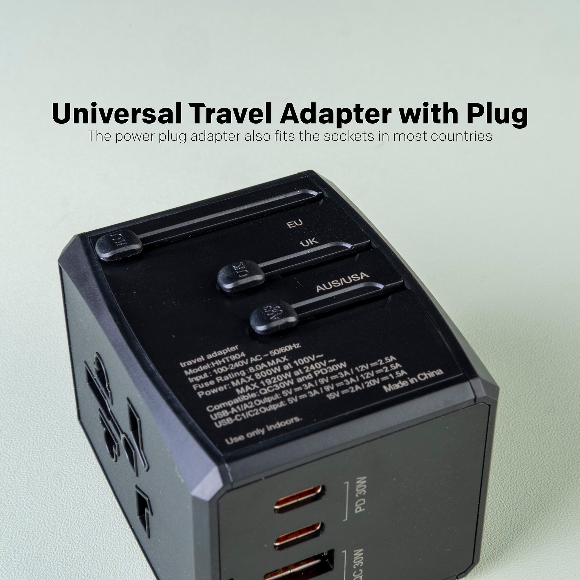 Universal travel adapter with plug on a light gray background